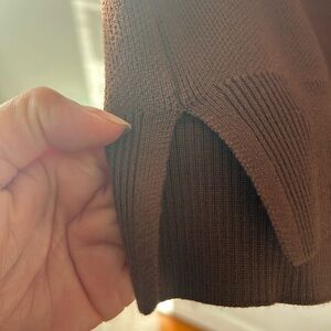 Sleeveless V-neck brown sweater.